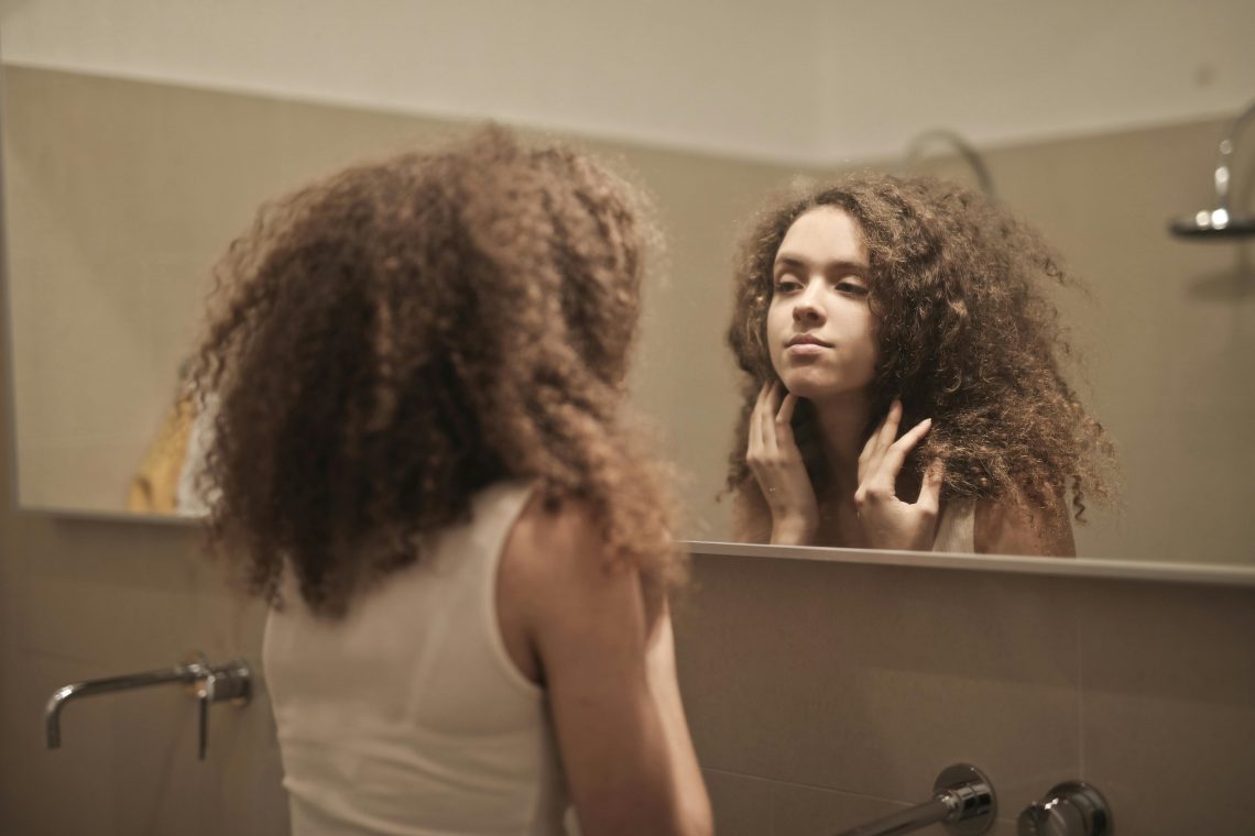 woman looking in a mirror