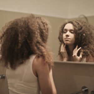 woman looking in a mirror