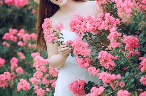 woman behind pink flowers
