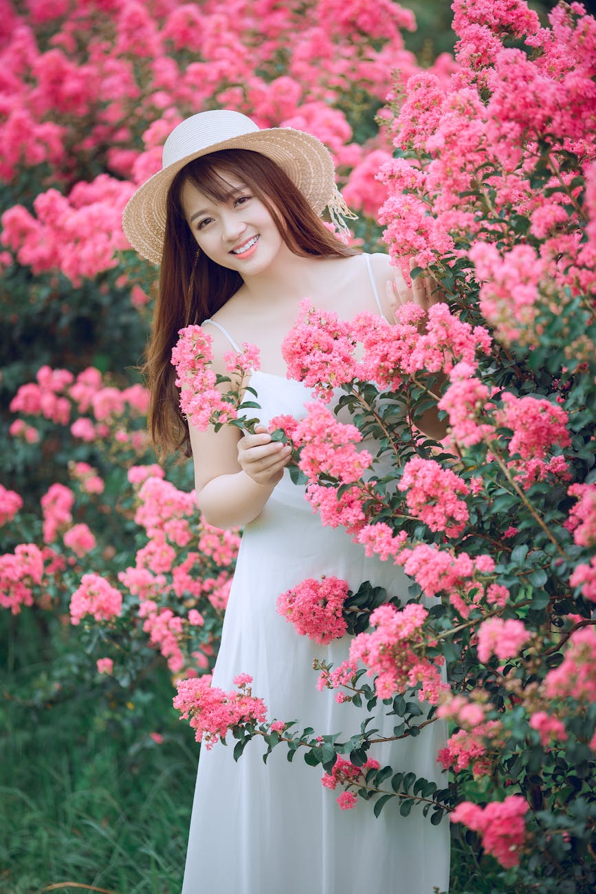 woman behind pink flowers
