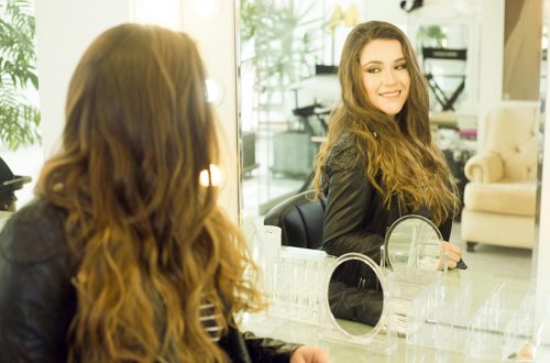 Woman admiring herself in a mirror - symbolizing reclaiming your identity as a mom.